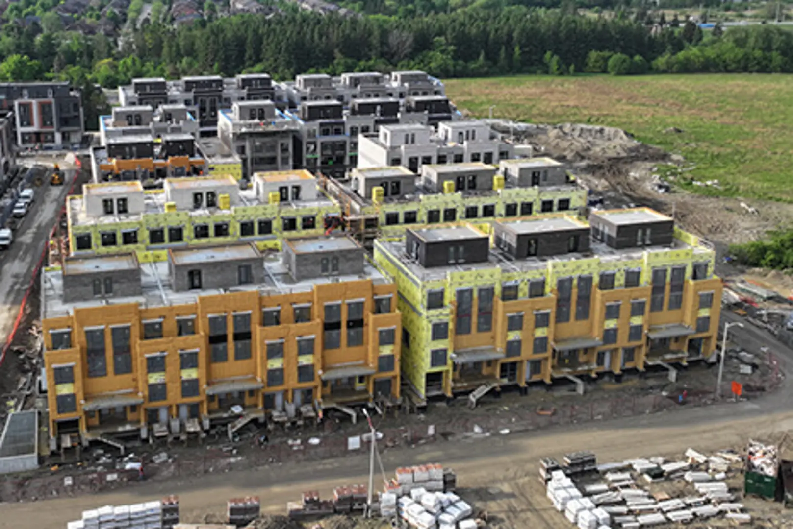 Aerial view of colorful townhouses under construction.