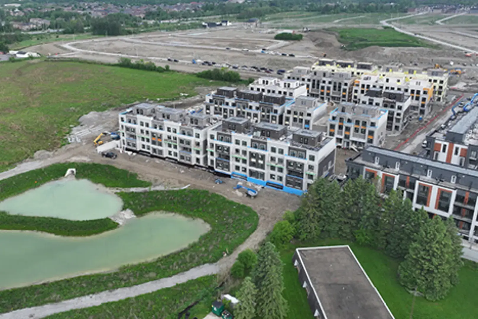 Aerial view of a residential complex under construction near a golf course.