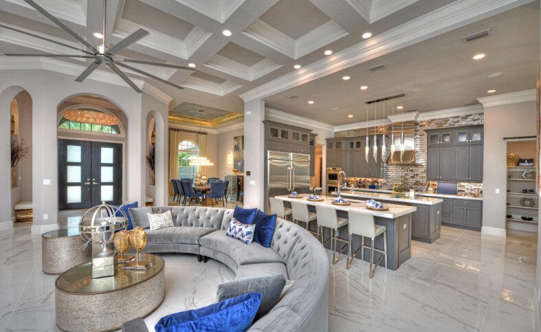 Luxurious open-concept living room and kitchen with modern decor and elegant lighting.