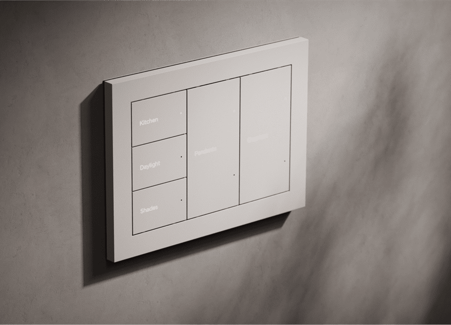 A modern light switch panel with multiple buttons on a textured wall.